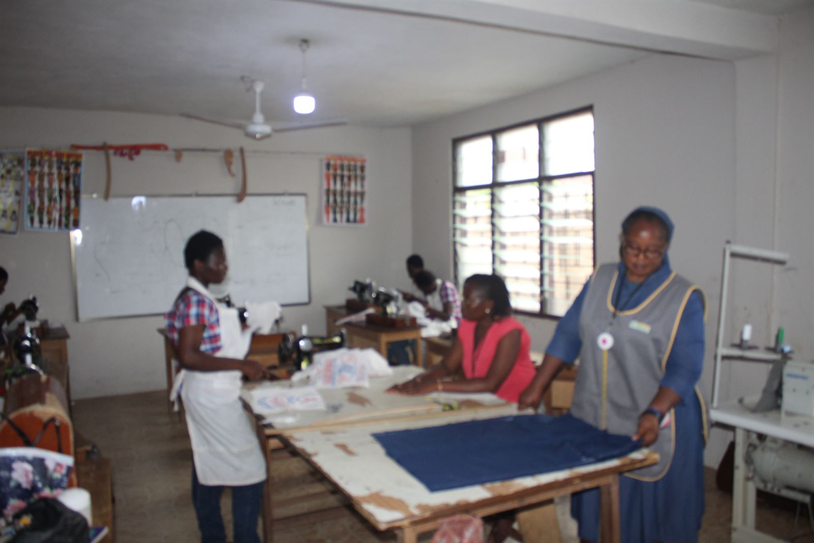 Dressmaking trainees learning with their instructor